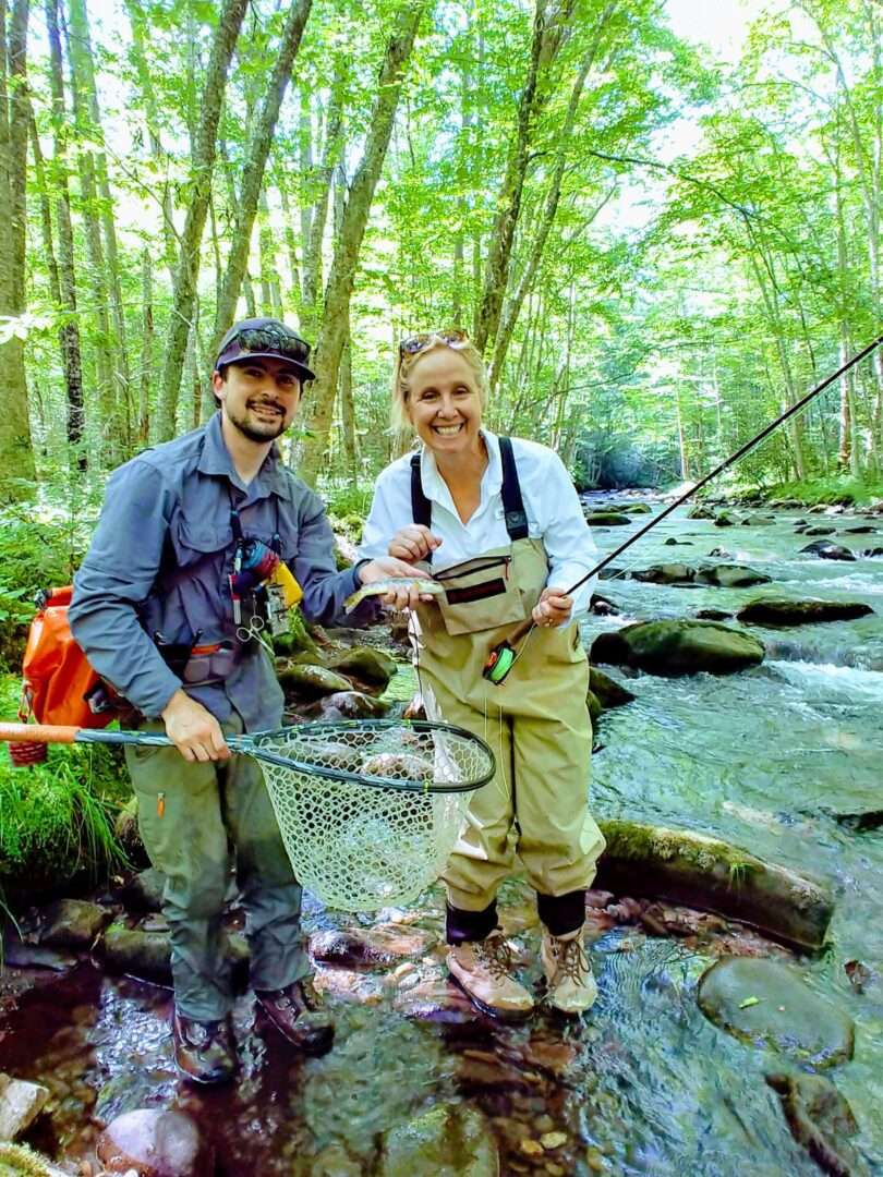 People doing fishing in a side of river