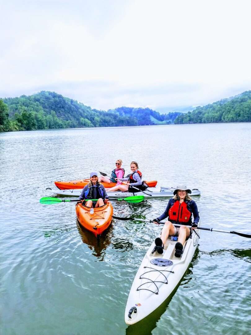 Some people boating in a long boat in a lake