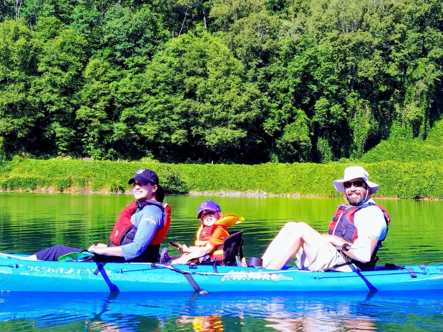A couple along with their children enjoying boat ride