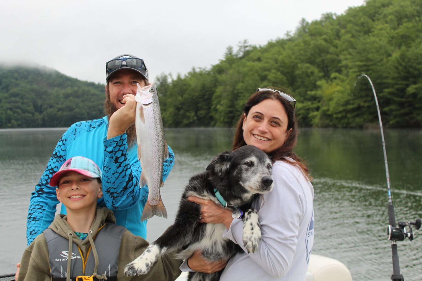 A family along with a kid and a dog and fish