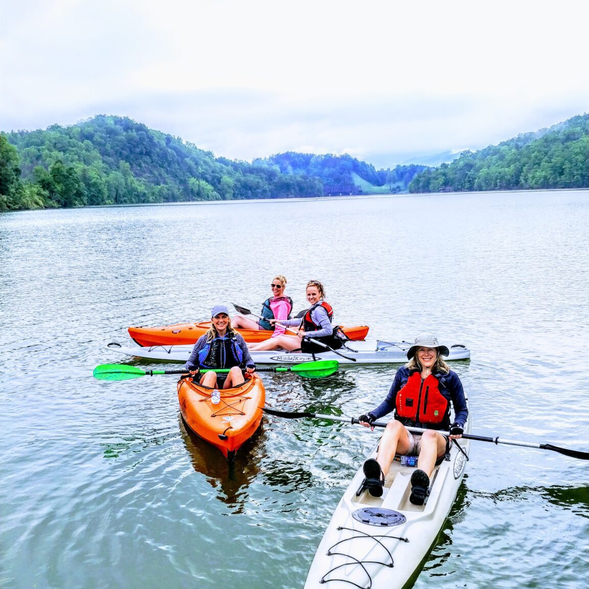 Some people boating in a long boat in a lake