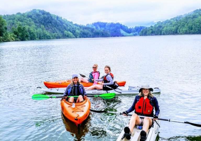 Some people boating in a long boat in a lake
